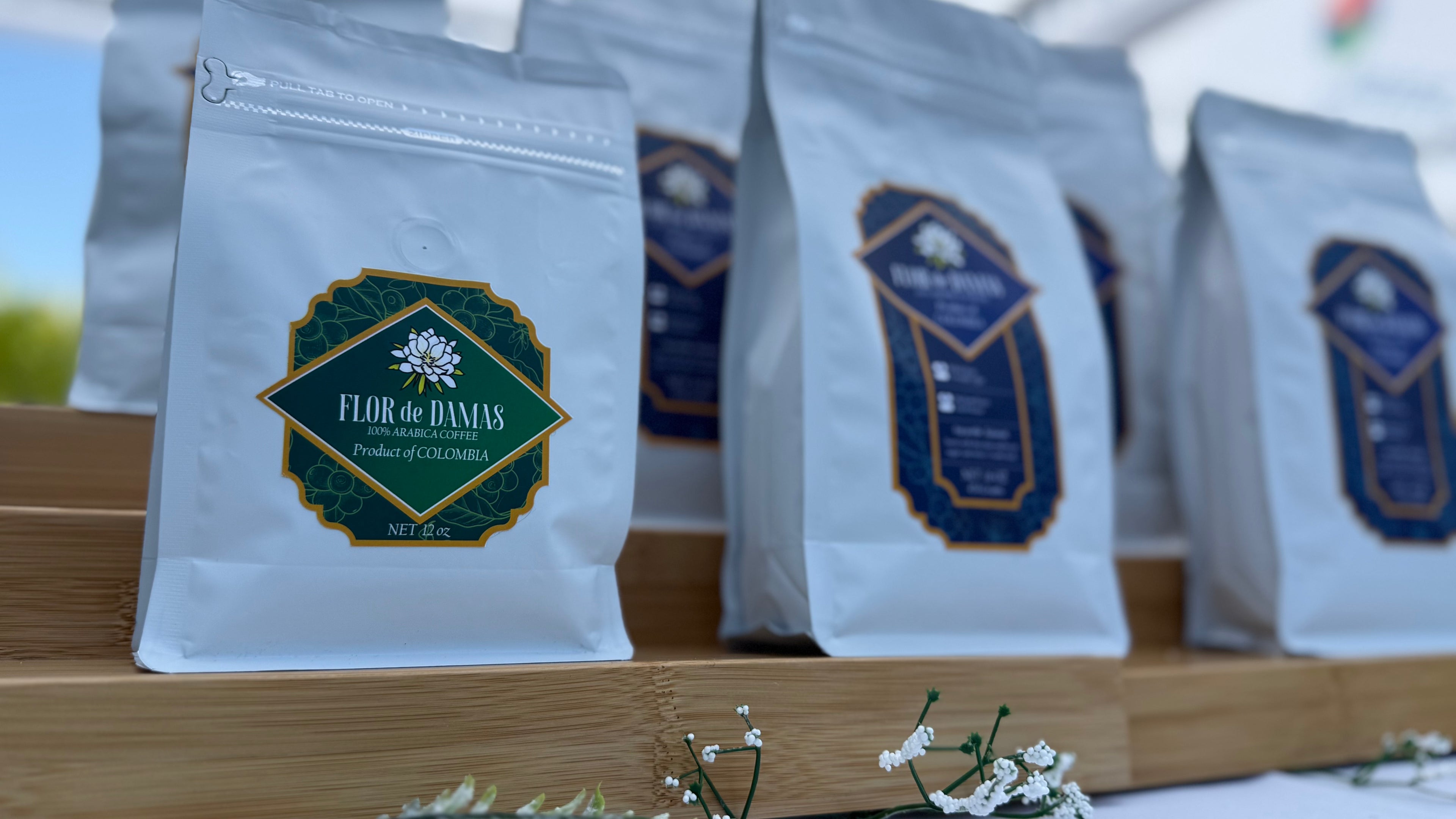 Organic single-origin Colombian coffee beans packed in multiple Flor de Damas packaging. 